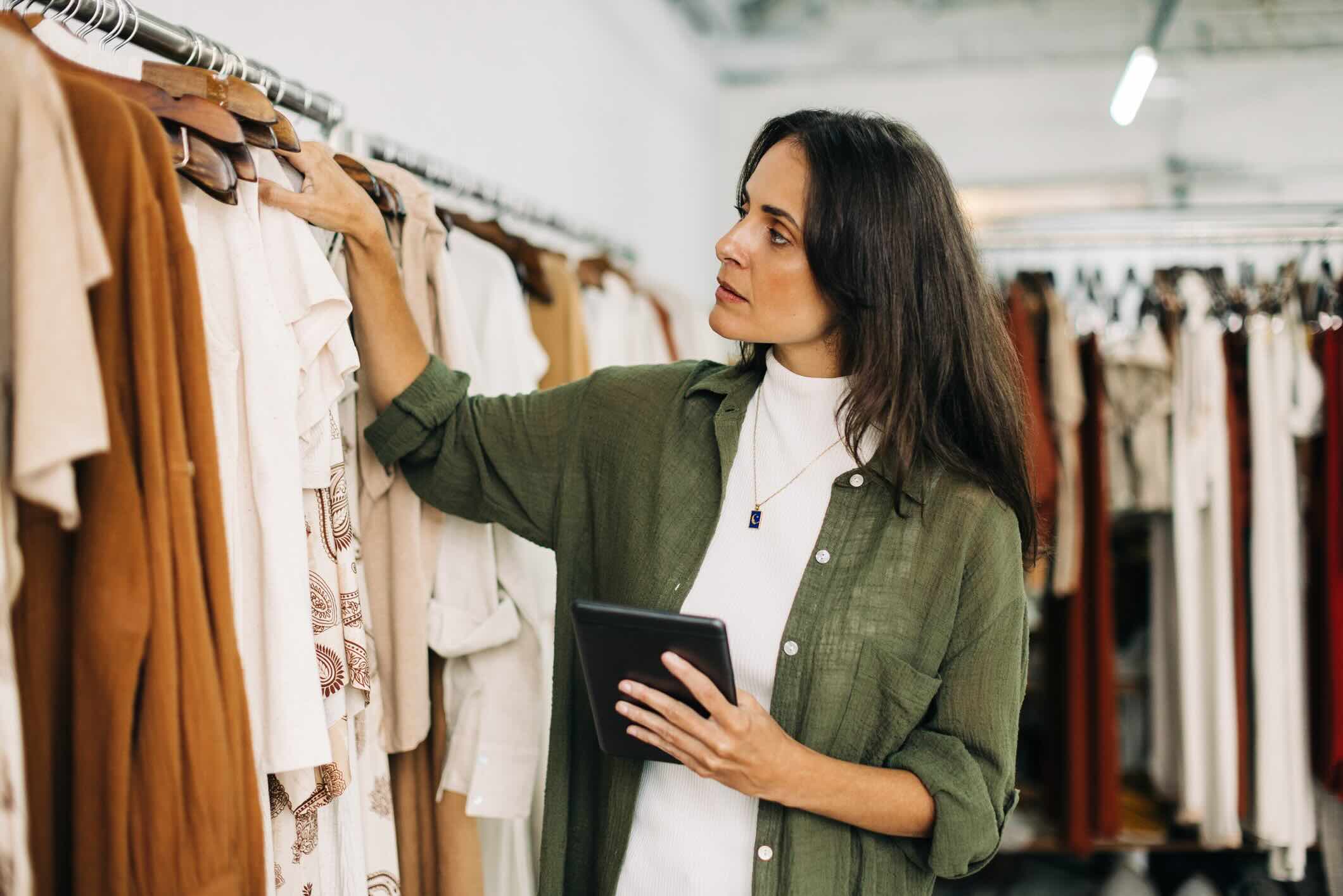 Women looking over stock of shirts