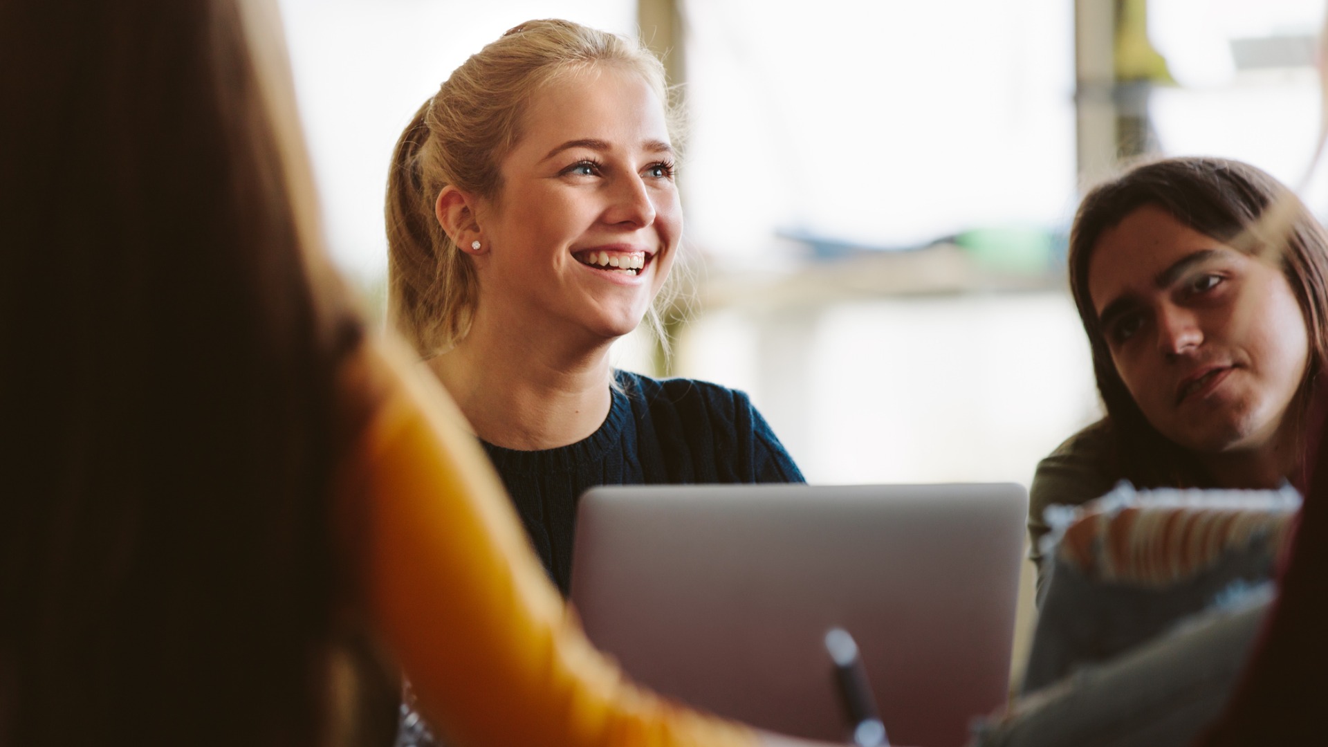 woman smiling at a laptop