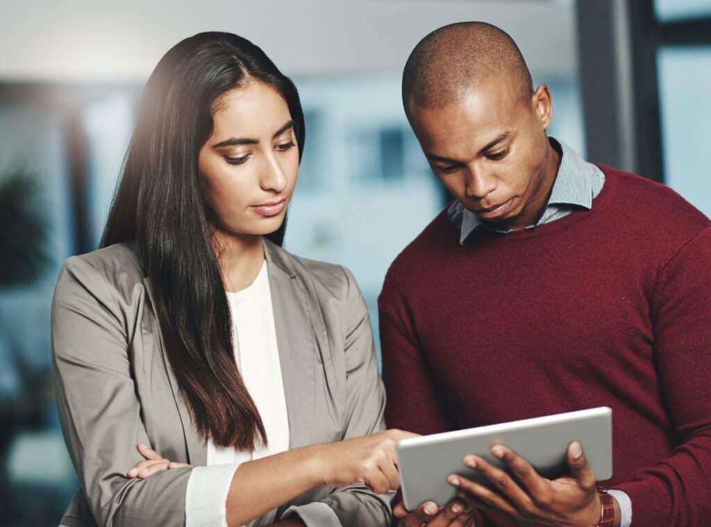 two workers using an ipad